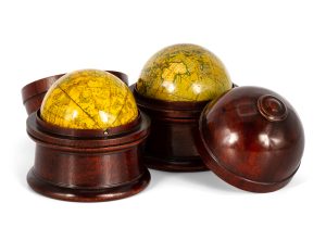 A matching pair of cased terrestrial and celestial pocket globes.